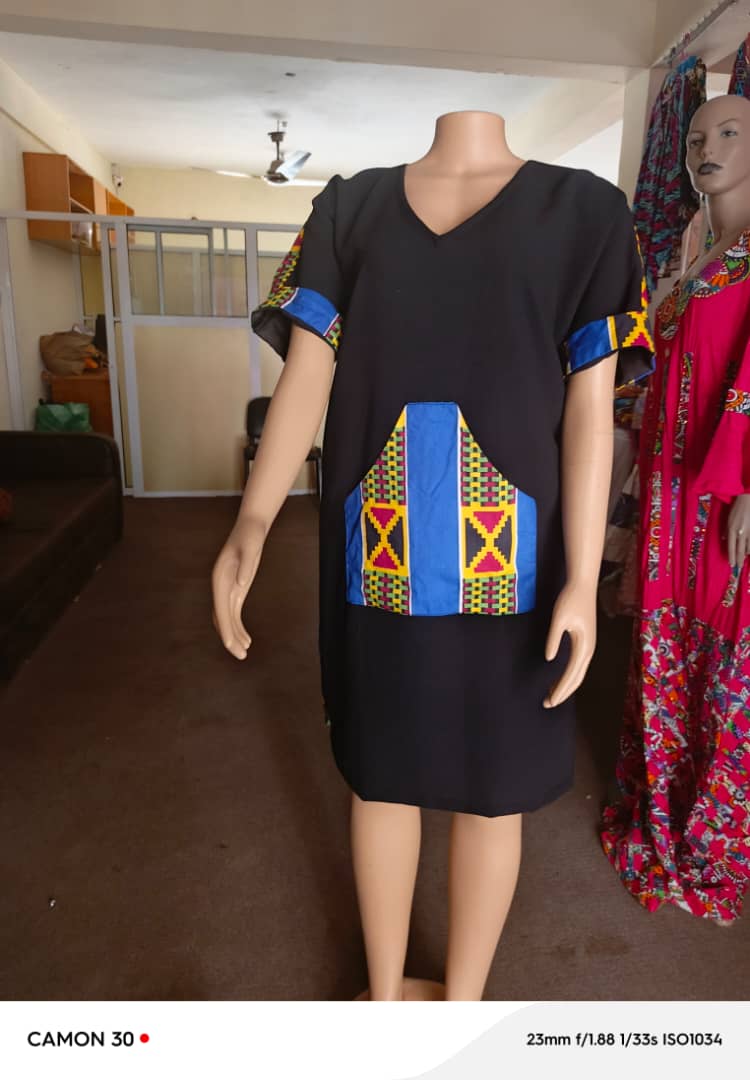 Black dress with blue African-print details on a mannequin
