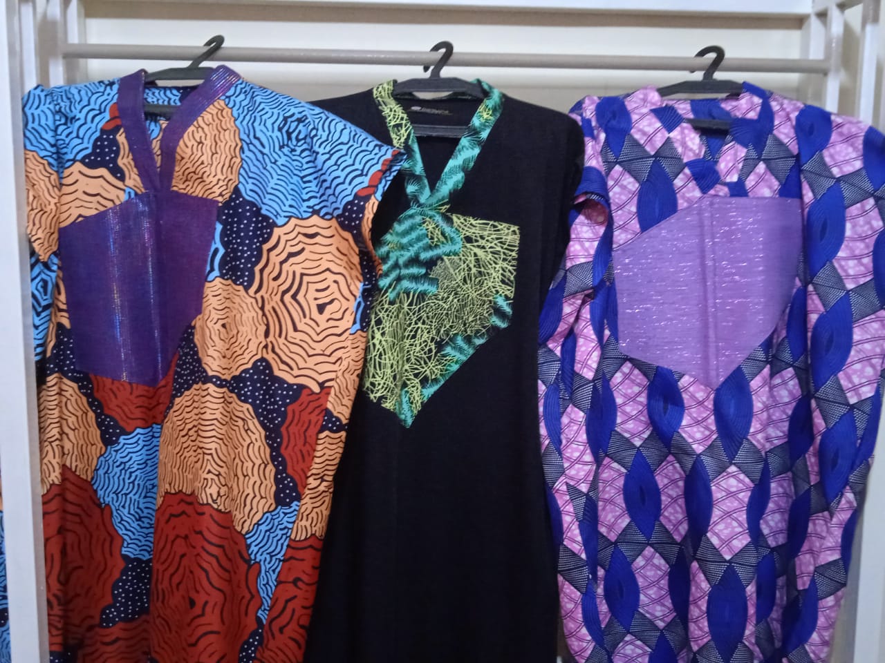 Three colourful African-print garments on display